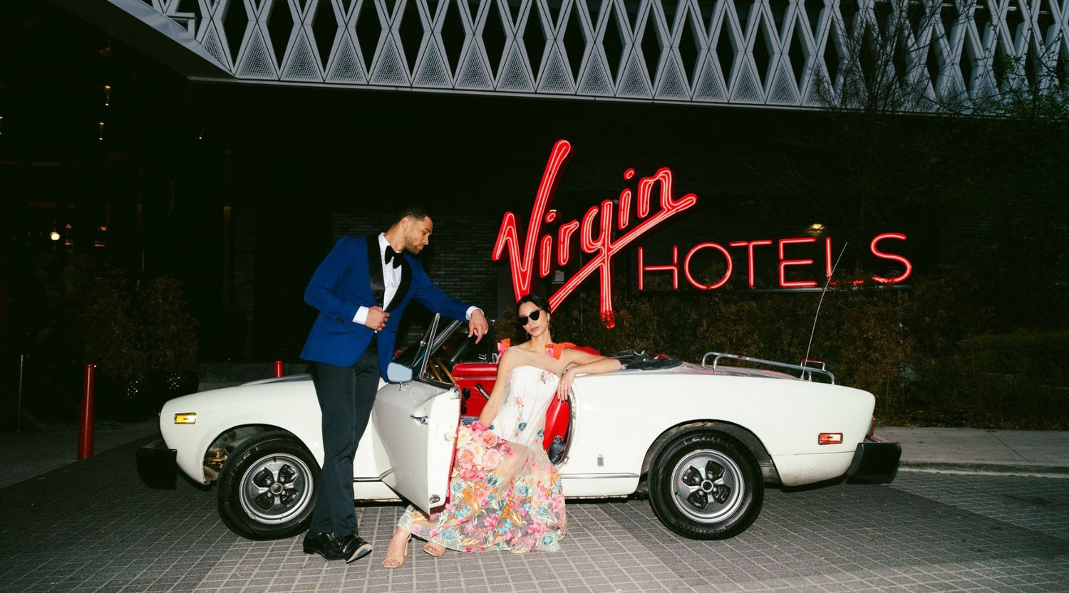 Bride and Groom Posing Outside Virgin Hotels Dallas with Classic Convertible - dbandrea